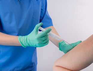 A doctor in a blue uniform gives a shot in the shoulder. Banner. Concept