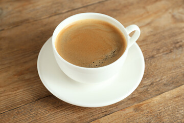 Cup of tasty coffee on wooden table