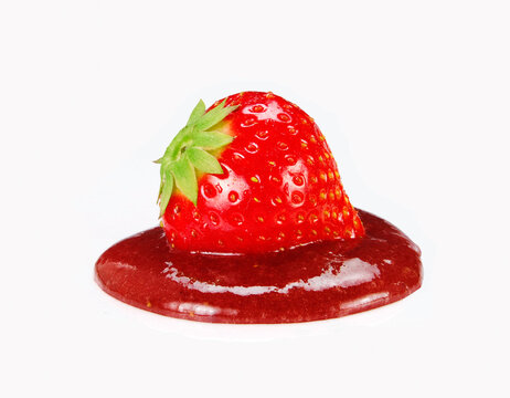 Strawberry fruit on strawberry jam isolated on white background.