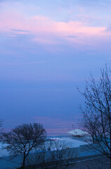 Dusk twilling on the Black sea in Odessa city beach. Early spring, blue evening, water horizon...