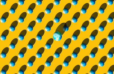 Pattern of easter eggs on yellow pastel background