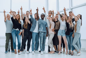 Fototapeta premium group of happy young people pointing upwards