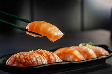 Salmon onigiri on chopsticks.