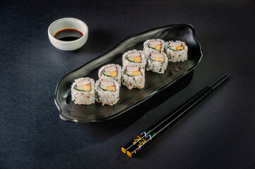 Uramaki with cucumber, mango fruit and crab sticks.