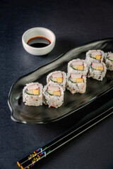 Uramaki with cucumber, mango fruit and crab sticks.