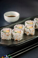Uramaki with cucumber, mango fruit and crab sticks.