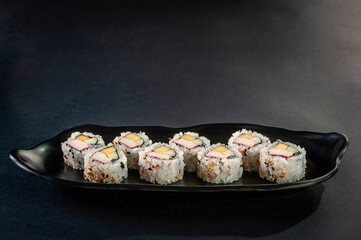 Uramaki with cucumber, mango fruit and crab sticks.