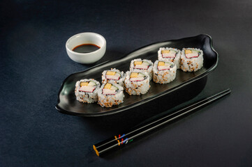 Uramaki with cucumber, mango fruit and crab sticks.