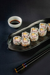 Uramaki with cucumber, mango fruit and crab sticks.