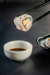 Uramaki with cucumber, mango fruit and crab sticks.