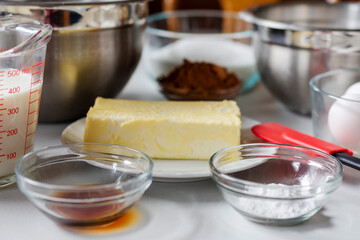 Ingredients arranged prior to baking.  Ingredients include: egg, milk, cocoa, butter, and baking powder.