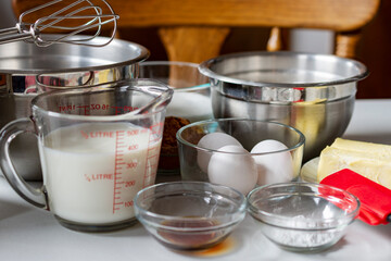 Ingredients arranged prior to baking.  Ingredients include: egg, milk, cocoa, butter, and baking powder.