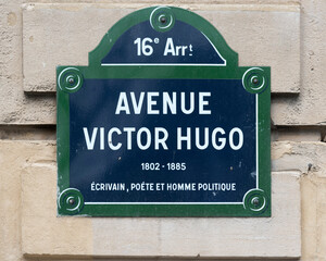 An Avenue Victor Hugo street sign in the 16th arrondissement of Paris France.