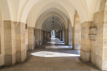 An arched hallway recedes in the distance of a church in Vienna Austria.