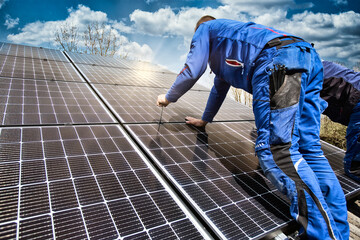 Installing solar photovoltaic panel system. Solar panel technician installing solar panels on roof....