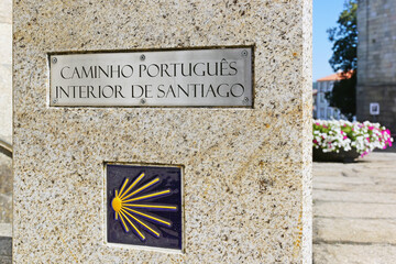 inner portuguese way to Santiago de Compostela with stone cairn and yellow  scallop shell sign in Viseu city , Portugal - obrazy, fototapety, plakaty