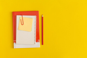 Notebook on yellow background. Top view. Flat lay. Back to school concept.