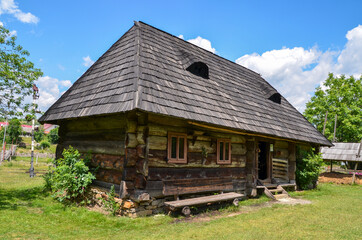 Fototapeta na wymiar Rural landscape of ancient old wooden houses in the traditional style in the mountain village Kolochava, Transcarpathia, Ukraine