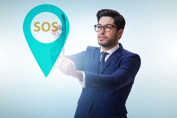 Businessman pressing SOS button in case of danger