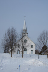Fototapeta na wymiar Old church in the Canadian winter in the province of Quebec