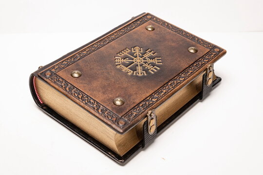 Leather book with the Vegvisir, ancient Icelandic magical symbol, in the center of the leather cover.