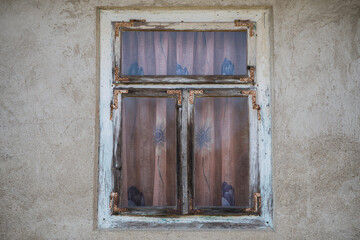 Fototapeta na wymiar Sunja, Croatia, 05,04,2021: Rustic style aged window in wooden village rural home wall.