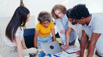 Group of young multi-ethnic entrepreneurs works as a team in the office. 