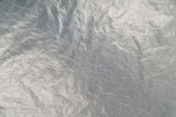 full frame background of flat crumpled semi-transparent polyethylene film