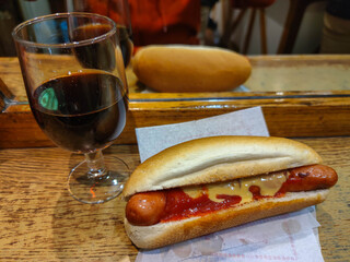 eating a traditional hot dog in a bar

