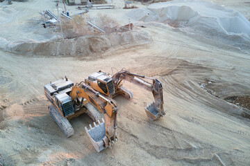 Open pit mining site of construction sand stone materials with excavator equipment for digging of...
