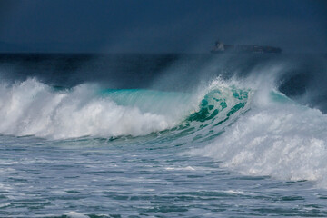 Large sea waves in winter. Sea lambs of the waves. Storm at sea. Coastal wave.