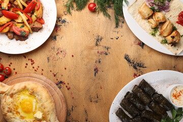 Georgian cuisine foodset from khachapuri, dolma, odjakhuri with meat and potatoes, chicken kebab top view with copy space for your text at the center