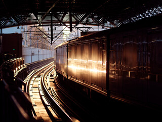 Obraz premium Subway train in motion on the railway station at sunset time.