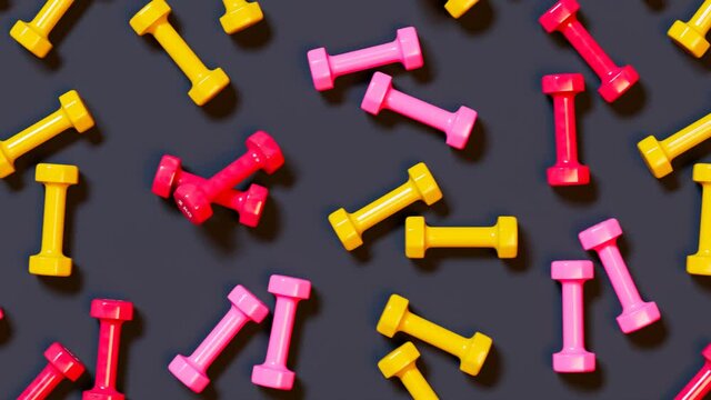 Many colorful small 2kg dumbbells on a fitness center floor. Sport equipment