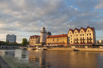 Fototapeta premium The Fishing Village and lighthouse on the banks of Pregolya River at sunset light, Kaliningrad, Russia