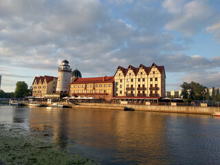 The Fishing Village and lighthouse on the banks of Pregolya River at sunset light, Kaliningrad, Russia