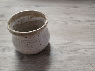 Neutral tone pottery on barn wood surface.