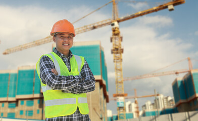 portrait of foreman construction worker on location new building site with crane in the background