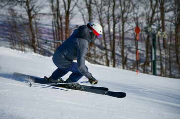 Active winter holidays, skiing downhill in sunny day. Dynamic picture