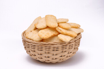Spicy rice cracker in a bamboo bowl with isolated white background