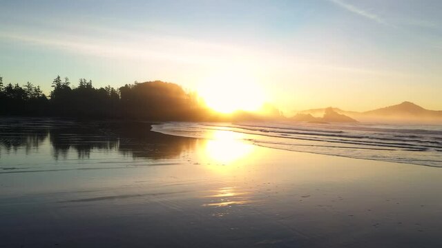 Sunrise Reflecting Off Of Sand At The Beach