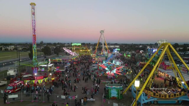 AERIAL: Carnival Ride with People during Sunset filmed on Mavic Pro 2 in 4k