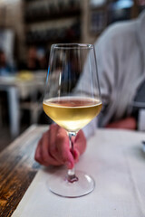 Dinner with sweet cold muscat white desert wine in traditional Italian osteria restaurant