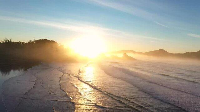 ocean and beach sunrise with fog and waves