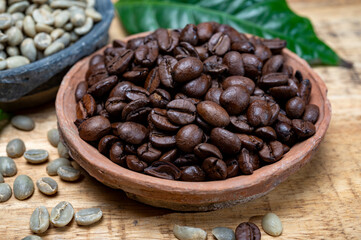 Green un-roasted and brown roasted coffee beans from Africa coffee producing region, cultivating in Ethiopia, Ivory Coast, Uganda, Kenya, Rwanda and Tanzania