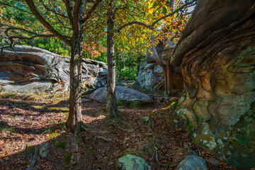 weathered stone monoliths amidst a fall colored woodland forest in Shawnee National Forest in Illinois