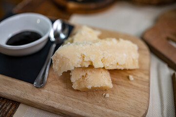 Tasting of different matured and very old parmesan Parmigiano-Reggiano hard cheese and balsamic vinegar of Modena in Parma, Emilia Romagna, Italy