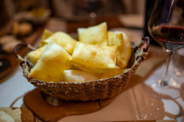 Food of Emilia Romagna region, deep fried bread gnocco fritto or crescentina served in restaurant in Parma, Italy