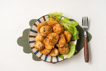 Deep fried cuttlefish ball with salted egg yolk coating