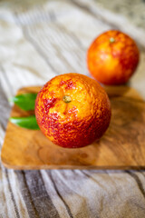 Sicilian sweet juicy yellow and red blood oranges with green leaves close up